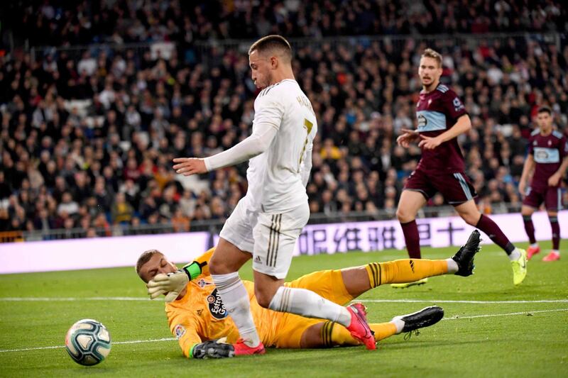Real Madrid's Belgian forward Eden Hazard is sent tumbling by Celta Vigo's Spanish goalkeeper Ruben Blanc. AFP