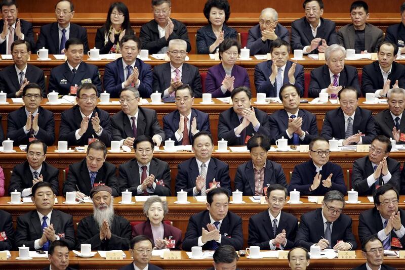 Delegates clap during the closing ceremony of the CPPCC at the Great Hall of the People, in Beijing, China. Jason Lee / Reuters