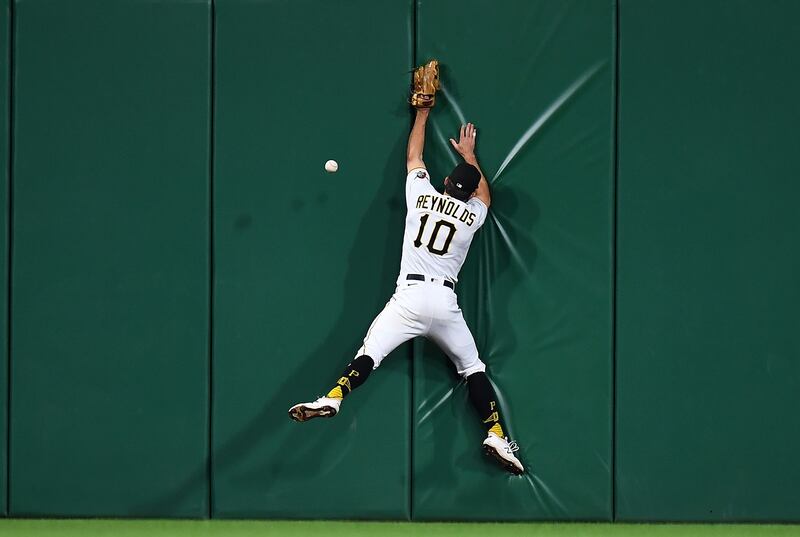 Pittsburgh Pirates' Bryan Reynolds fails to catch a ball hit by Jose Barrero of the Cincinnati Reds during the MLB game at PNC Park in Pennsylvania, on Friday, October 1. AFP