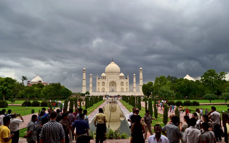 FILE- In this July 21, 2012 file photo, monsoon clouds hover over the Taj Mahal in Agra, India. India's famed monument of love, the white marble Taj Mahal, is finding itself at the heart of a political storm with some members of India's ruling Hindu right-wing party claiming that the mausoleum built by a Muslim emperor does not reflect Indian culture. (AP Photo/Pawan Sharma, File)