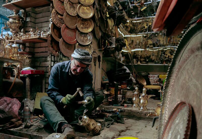 Mohammed Mohsen works in his antiques shop in central Baghdad, Iraq. AP Photo