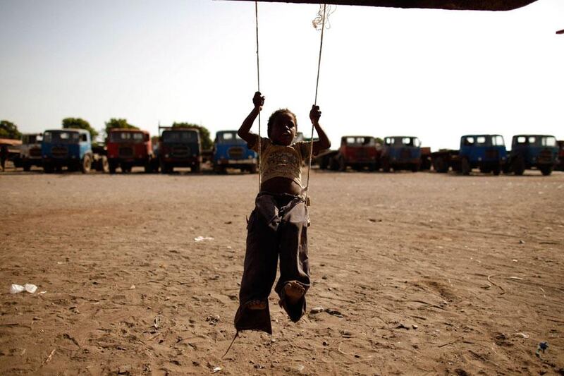 A boy plays on a makeshift swing near a slum area of the Akhdam community, where he lives.