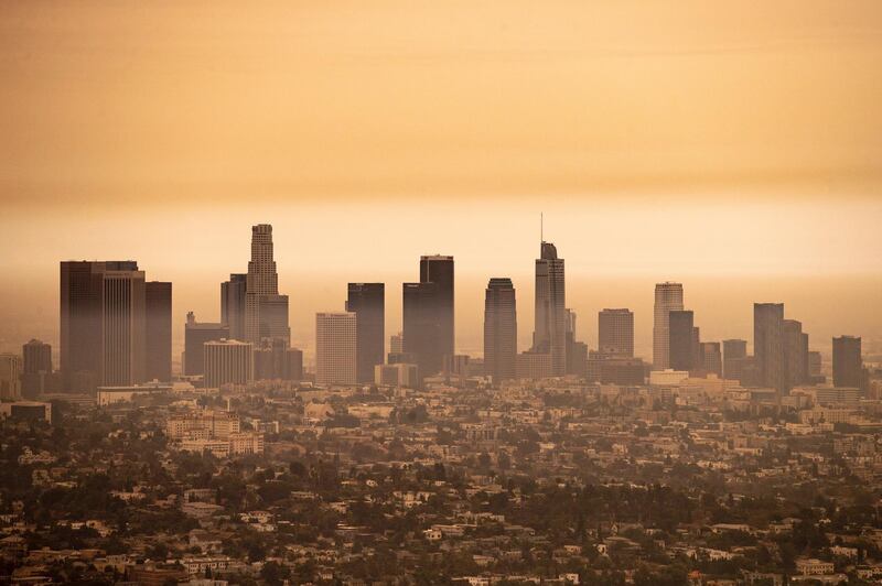 A view of downtown Los Angeles under an orange overcast sky. EPA