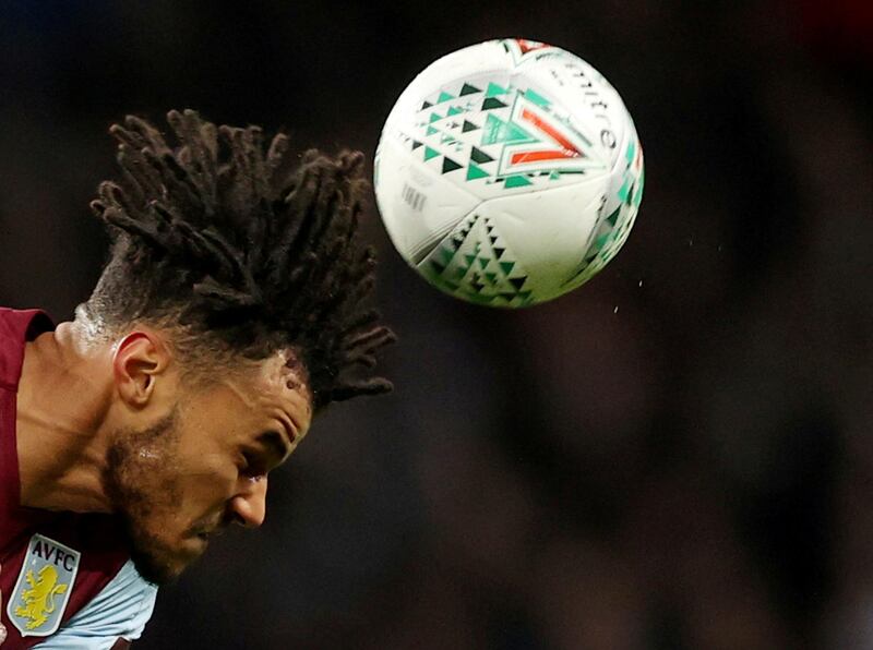 Aston Villa's Tyrone Mings heads the ball. Reuters