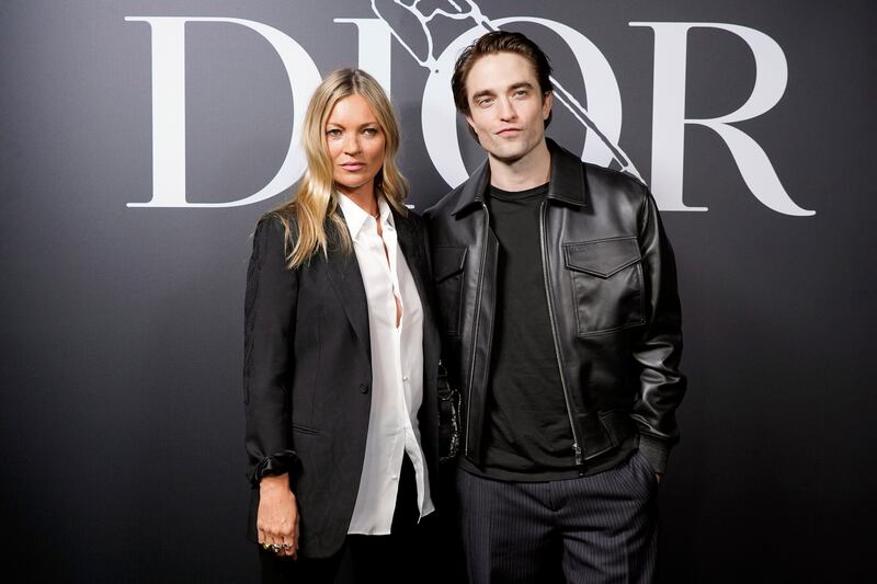 Robert Pattinson, in striped trousers, a black T-shirt and black leather jacket, and Kate Moss attend the Dior Homme Menswear autumn/winter 2020-2021 show on January 17, 2020. Getty Images