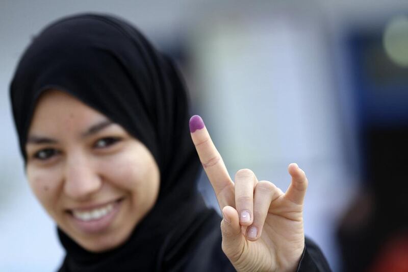 A woman leaves a polling station in Tunis after casting her vote in yesterday’s run-off election.  Anis Mili / Reuters