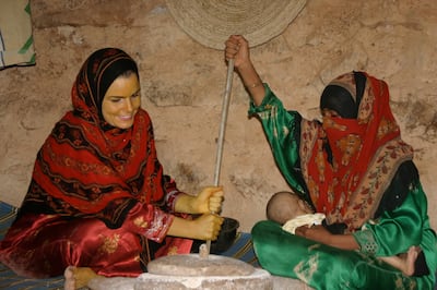 Grinding wheat in the countryside, Socotra. Nathalie Peutz is seated on the left, her face and hands yellowed with turmeric powder (a local sunscreen), 2005. Courtesy Nathalie Peutz