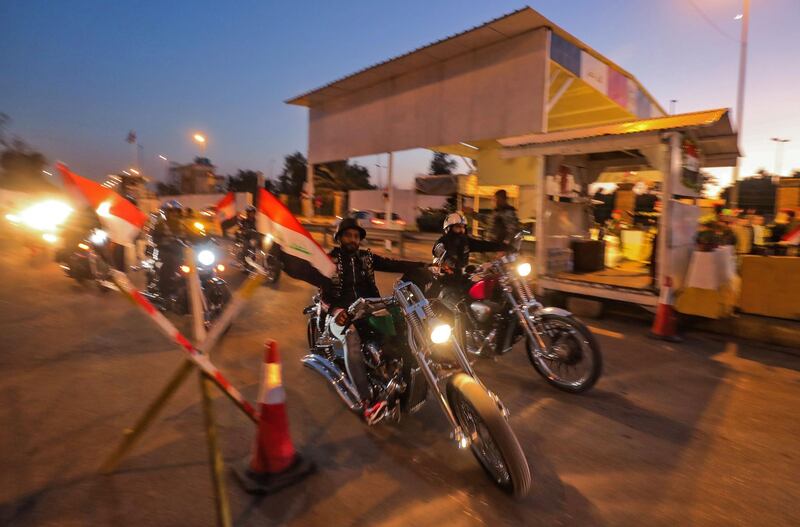 Motorcyclists cross a checkpoint as they celebrate the re-opening of the Green Zone. AFP
