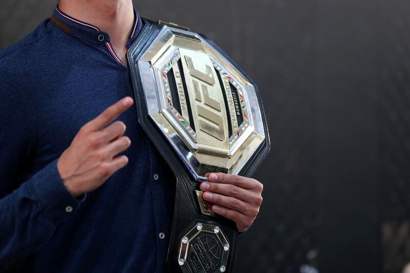 Abu Dhabi, United Arab Emirates - September 06, 2019: A man holds the belt at the UFC fan zone. Friday the 6th of September 2019. Yes Island, Abu Dhabi. Chris Whiteoak / The National