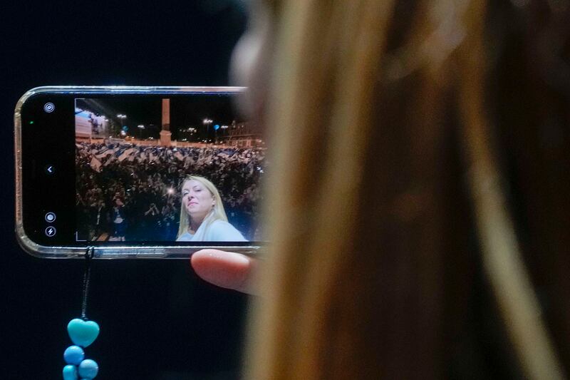Giorgia Meloni snaps a selfie at a rally in Rome. AP