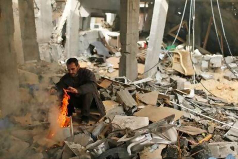 A Palestinian warms himself at the rubble of his house destroyed in an Israel air strike during last week’s strike on Gaza. Diplomats say greater UN recognition would help to heal Fatah’s political wounds.
