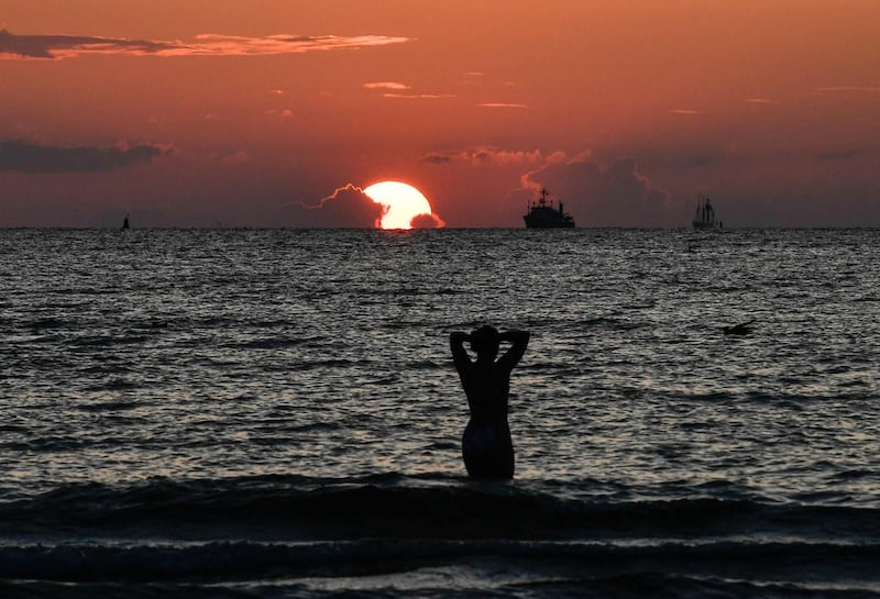 A woman enjoy bath in the Baltic Sea during sunset in spa town of Warnemuende, near Rostock, Germany.  EPA