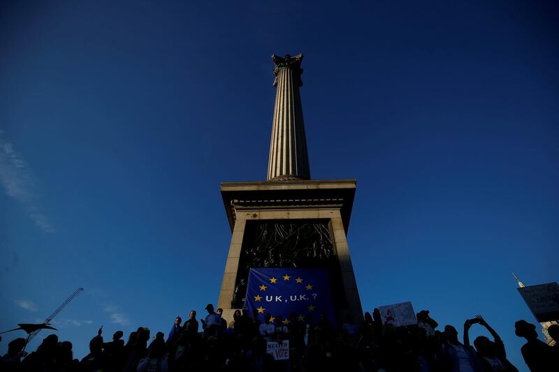 Protesters participating in an anti-Brexit demonstration march sit at the base of Nelson's Column, in Trafalgar Square, in central London, UK. Reuters