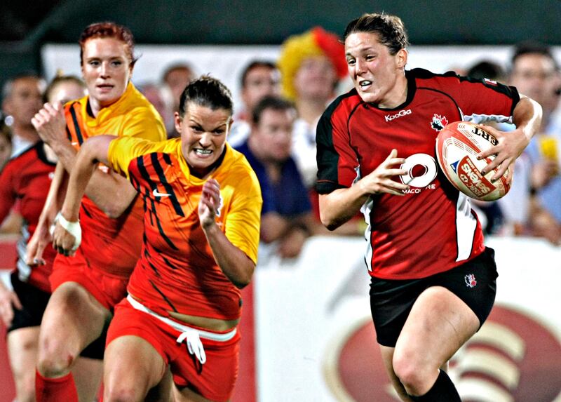 Dubai December 3, 2011 - Canada's Ashley Steacy outruns England players during the finals of the Women's Emirates Airlines Dubai Rugby Sevens tournament at the Rugby Sevens stadium in Dubai, December 3, 2011. Canada defeated England 26-7. (Photo by Jeff Topping/The National)
