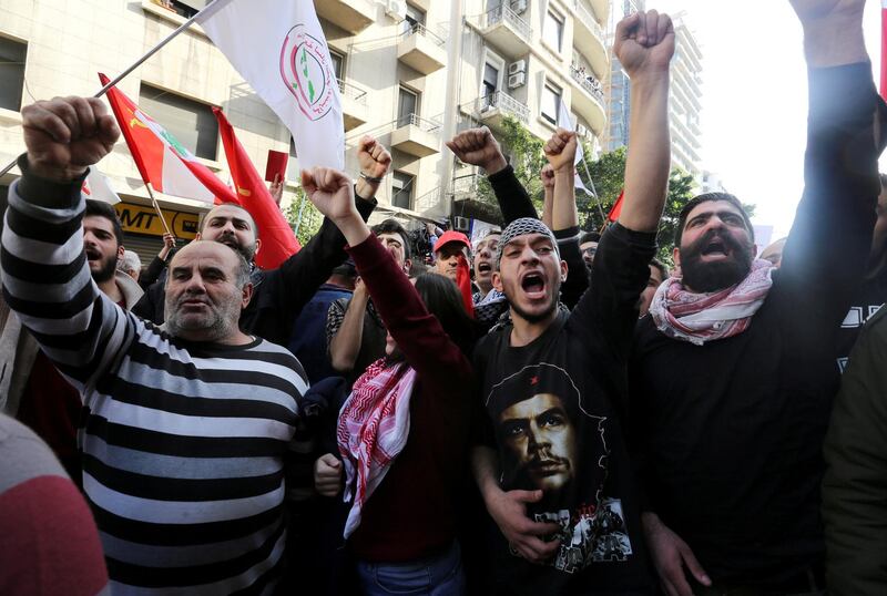 FILE PHOTO: People hold flags and chant slogans as they take part in a protest over the country's economic and political troubles, in Beirut, Lebanon January 20, 2019. REUTERS/Aziz Taher/File Photo
