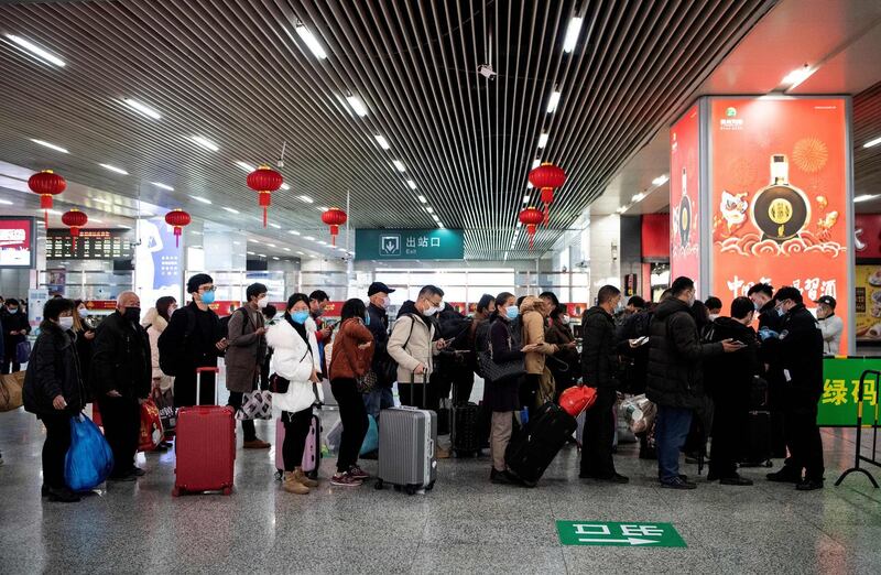 Passengers wearing face masks queueing to show a green QR code on their phones to show their health status to security upon arrival at Wenzhou railway station in Wenzhou. The National Health Commission on March 1 reported 573 new infections, bringing the total number of cases in mainland China to 79,824. AFP