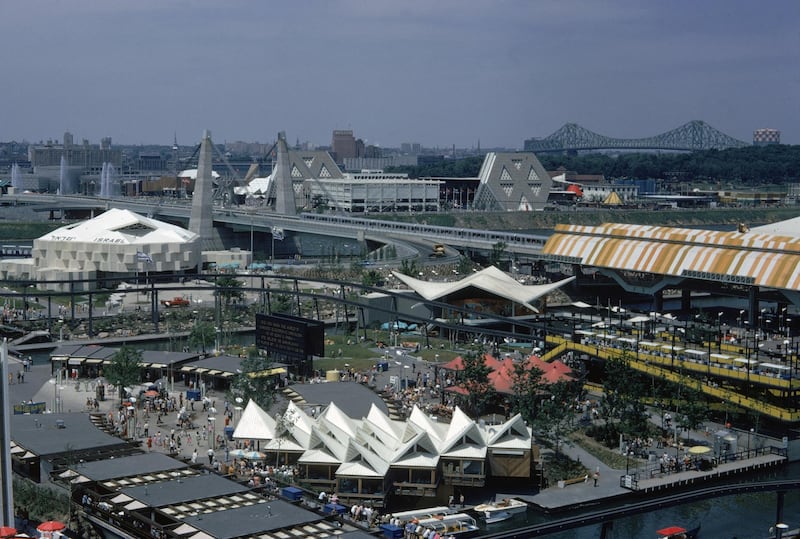 Aerial view of the 1967 Expo fairgrounds in Montreal, Canada, 1967. A monorail runs throughout the middle of the fairgrounds, next to the Place D'Accueil entranceway (center). To the left is the Israeli pavillion. In the background to the top right are the prominant hexagonal structures and Jacques Cartier Bridge.  (Photo by Harvey Meston/Getty Images)