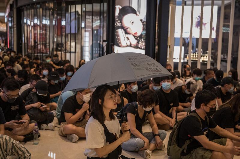 HONG KONG, CHINA - SEPTEMBER 21: Pro-democracy protesters sing songs and shout slogans as they gather in a shopping mall during a rally in Yeun Long district on September 21, 2019 in Hong Kong, China. Pro-democracy protesters have continued demonstrations across Hong Kong, calling for the city's Chief Executive Carrie Lam to immediately meet the rest of their demands, including an independent inquiry into police brutality, the retraction of the word riot to describe the rallies, and genuine universal suffrage, as the territory faces a leadership crisis. (Photo by Chris McGrath/Getty Images)