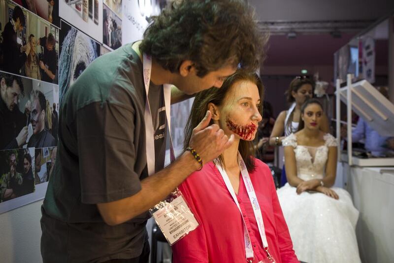 Make Up Artist Arash Fard  makes up a model using complete special effects at the make-up designory stand at the Beautyworld trade show held at Dubai World Trade Center. Antonie Robertson / The National 