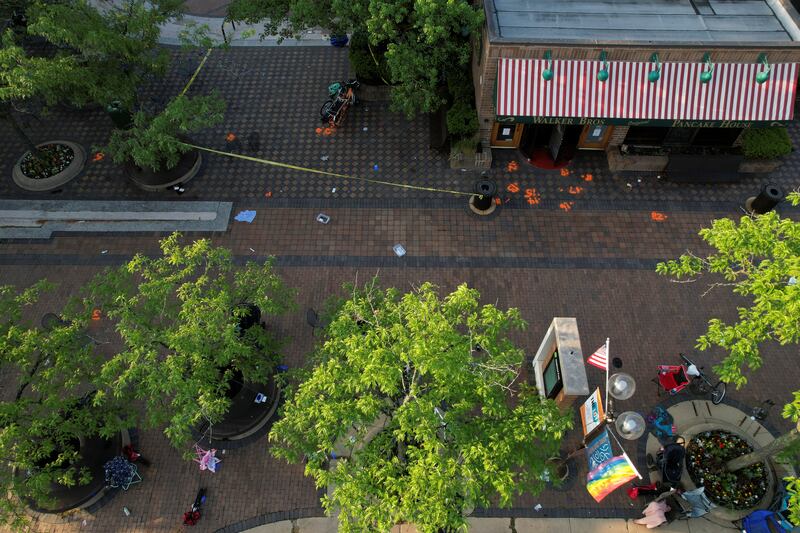 Spray paint on the ground marks evidence along the parade route. Reuters