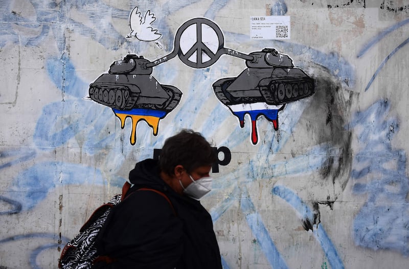A painting on a wall near the Russian embassy in Rome, by street artist Laika 1954, shows Russian and Ukrainian tanks making the peace symbol. AFP