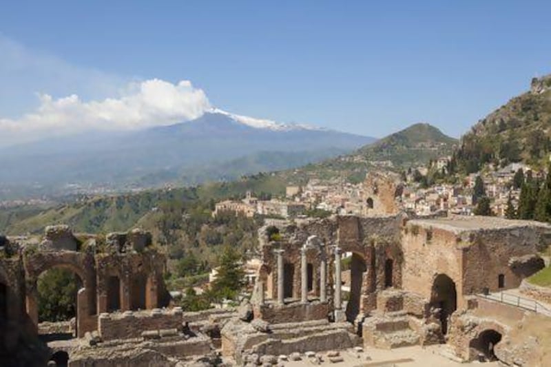 The ancient Greco-Roman amphitheatre in Taormina, Sicily, with Mount Etna, one of the most active volcanoes in Europe, visible in the distance. Getty Images