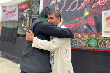 Mohammad Jan, right, 29 and a Sunni Muslim, greets an Afghan Shiite on the occasion of Ashura in Kabul on August 29, 2020.