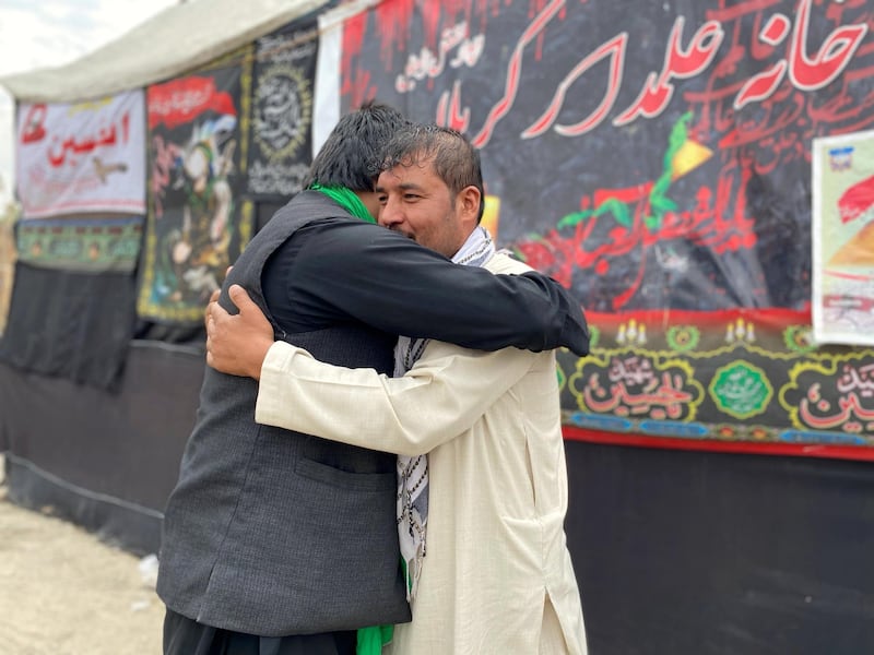 Mohammad Jan, right, 29 and a Sunni Muslim, greets an Afghan Shiite on the occasion of Ashura in Kabul on August 29, 2020.