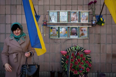 A widowed Ukrainian at a memorial to people killed in Bucha, Ukraine, in April 2022. AP 