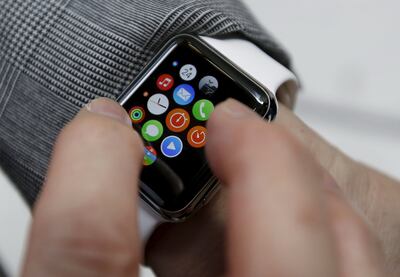 A customer uses his newly purchased Apple Watch in Tokyo. Reuters