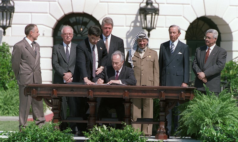 Shimon Peres, the Israeli foreign minister at the time, signs the Oslo Accords on September 13, 1993, at the White House. AFP