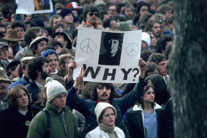 December 1980:  Fans of John Lennon holding a vigil after he was shot dead by a fan on December 8th at his home in New York.  (Photo by Hulton Archive/Getty Images)