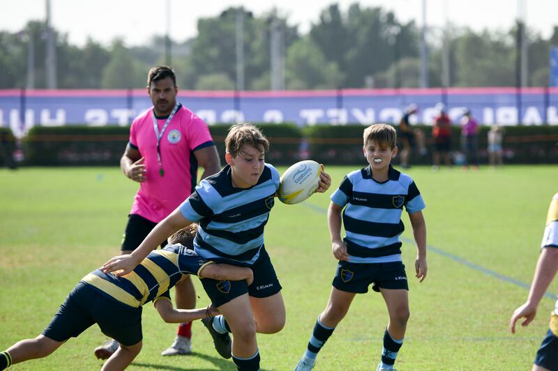 An Arcadia player is tackled by a Cranleigh player. Khushnum Bhandari / The National