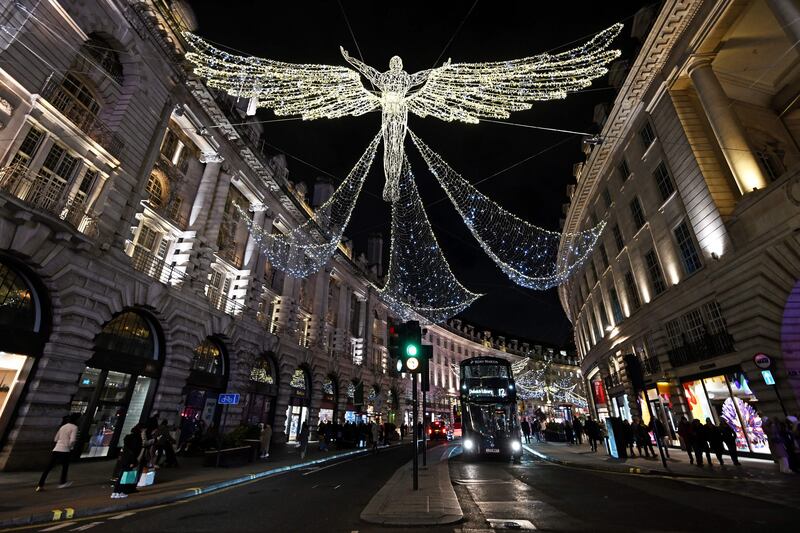Members of the public look at the annual Christmas lights on Regent Street in central London.  AFP