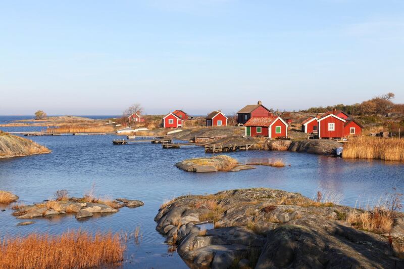 Small red cottages in autumn in outer archipelago of Stockholm.