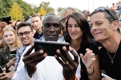 Eliud Kipchoge takes a selfie after winning the 45th Berlin Marathon in Berlin, Germany, Sunday, Sept. 16, 2018. Eliud Kipchoge set a new world record in 2 hours 1 minute 39 seconds. (AP Photo/Markus Schreiber)