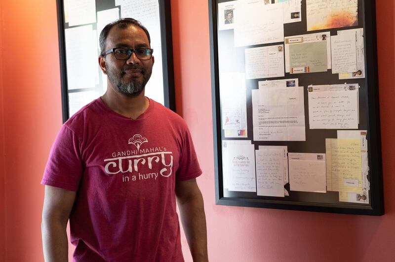 Ruhel Islam poses in front of thank you cards sent to him after he expressed his continued support for the Black Lives Matter protests even after his restaurant was burned down. Willy Lowry / The National