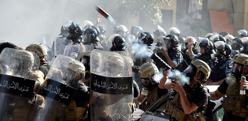 Riot police fire tear gas against anti-government protesters during a protest outside of the Lebanese Parliament. EPA