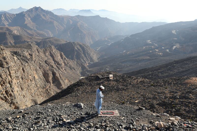 Praying on top of Jebel Jais, in Ras Al Khaimah, on New Year's Day. Chris Whiteoak / The National