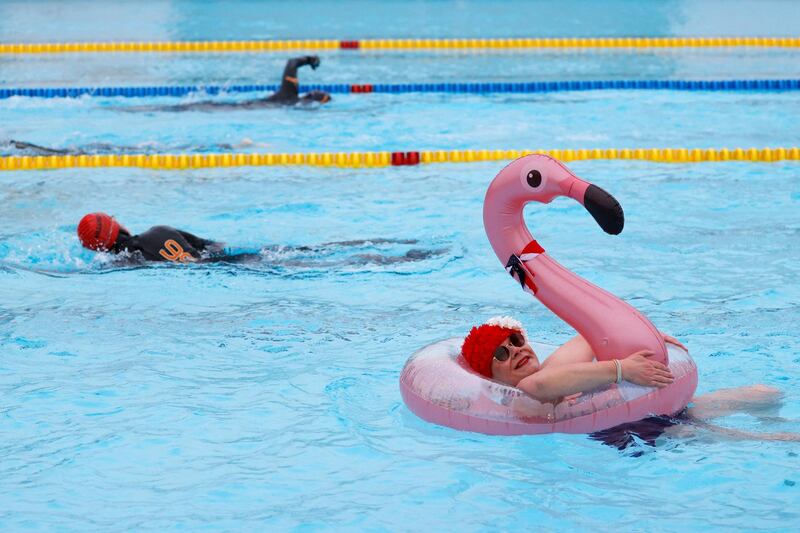Nicole Foster swims with the aid of an inflatable flamingo at Hillingdon Lido in west London as Covid-19 lockdown restrictions ease to allow outdoor sports facilities to open. AFP