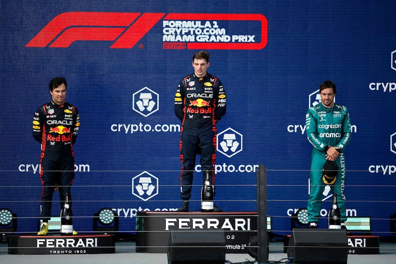 Race winner Max Verstappen, centre, with second-placed Sergio Perez, left, and Fernando Alonso, right, who finished third. Getty