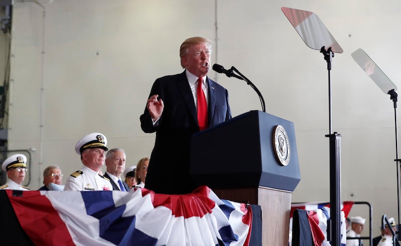 President Donald Trump speaks during the commissioning ceremony of the aircraft carrier USS Gerald R. Ford (CVN 78) at Naval Station Norfolk, Va., Saturday, July, 22, 2017. Seated behind the president are Defense Secretary Jim Mattis, fourth from left, and Ships Captain Rick McCormack, third from left. (AP Photo/Carolyn Kaster)