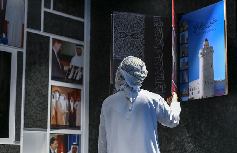 Abu Dhabi, United Arab Emirates - Visitor educates himself through photos, films and artifacts of the United Arab Emirates history in the National Archives pavilion at Sheikh Zayed Heritage Festival, Al Wathba. Khushnum Bhandari for The National