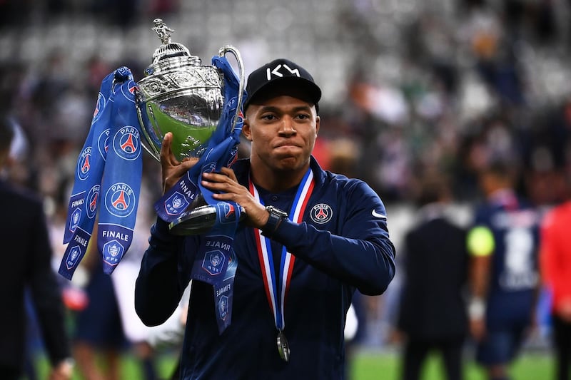 Mbappe celebrates with the trophy. AFP