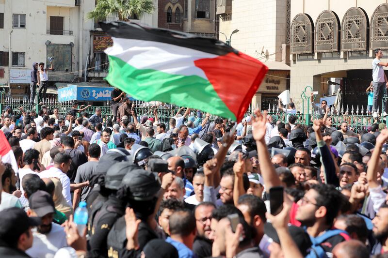 Protesters wave a Palestinian flag during a demonstration in Old Cairo. Protests were held in cities across Egypt. Reuters