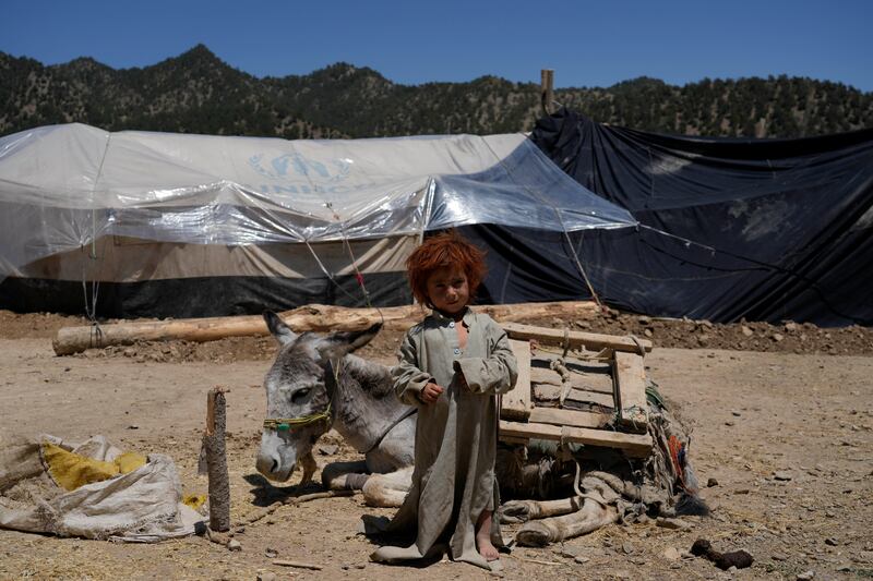 A child stands in front of a makeshift shelter after an earthquake in Gayan village, in Paktika province, Afghanistan, on June 24. AP