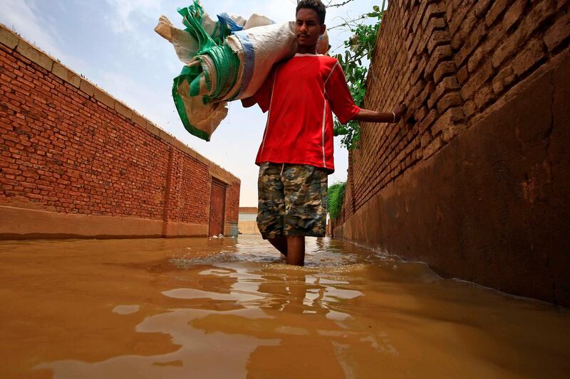 A Sudanese man stands in flood waters in Tuti island, where the Blue and White Nile merge in the Sudanese capital Khartoum. AFP