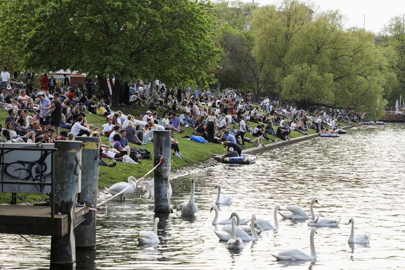 People enjoy the sunny weather on the bank of the Landwehrkanal in Berlin, Germany. Reuters