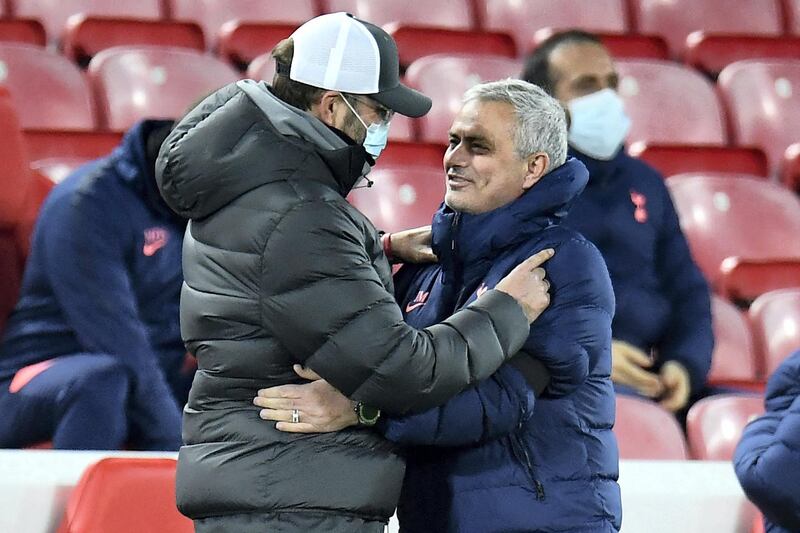 Liverpool's German manager Jurgen Klopp (L) wearing a face mask or covering due to the COVID-19 pandemic, greet Tottenham Hotspur's Portuguese head coach Jose Mourinho ahead of the English Premier League football match between Liverpool and Tottenham Hotspur at Anfield in Liverpool, north west England on December 16, 2020. (Photo by PETER POWELL / POOL / AFP) / RESTRICTED TO EDITORIAL USE. No use with unauthorized audio, video, data, fixture lists, club/league logos or 'live' services. Online in-match use limited to 120 images. An additional 40 images may be used in extra time. No video emulation. Social media in-match use limited to 120 images. An additional 40 images may be used in extra time. No use in betting publications, games or single club/league/player publications. / 