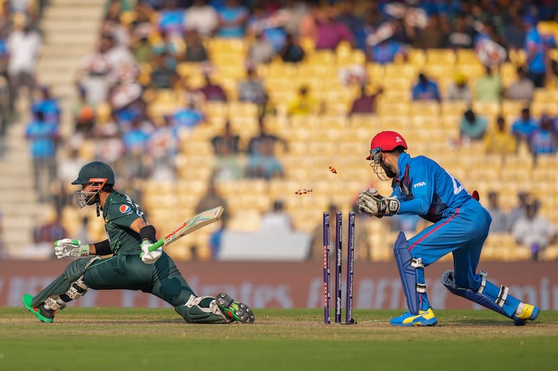 Afghanistan's wicketkeeper Rahmanullah Gurbaz unsuccessfully attempts to stump out Pakistan's Mohammad Rizwan. AP 